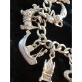Stunning-heavy genuine silver charm bracelet with all the charms