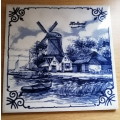 A Collection of three Delft tiles with windmill theme and one tile holder