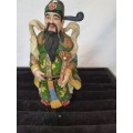 A CHINESE FIGURINE LOOKS LIKE THE PHILOSIPHER CONFUSCIOUS WITH A PIECE OF HIS HAT MISSING