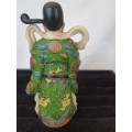 A CHINESE FIGURINE LOOKS LIKE THE PHILOSIPHER CONFUSCIOUS WITH A PIECE OF HIS HAT MISSING