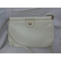 A VINTAGE GUCCI SLING HAND BAG IN MINT CONDITION WHITE IN COLOUR SOLD AS IS