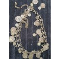 A VINTAGE ORNATE COIN BRONZE NECKLACE WITH 2 COINS LOOSE SOLD AS IS