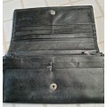 A GENUINE BUSBY USED BLACK LEATHER WALLET SOLD AS IS