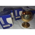 A VINTAGE SET OF 4 GOLD AND SILVER PLATED BRANDY GOBLETS SOLD AS IS