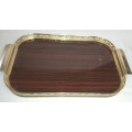 A VINTAGE WOOD DESINGED BRASS HANDLED SERVING TRAY SOLD AS IS