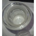 A SET OF 2 STORAGE GLASS BOTTLE CONTAINERS THE ONE LID WAS REPAIRED BEFORE SOLD AS IS
