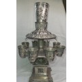 A VINTAGE QUILTED EMBLEM DESIGN SIVERPLATED  KIDDUSH WINE FOUNTAIN WITH 1 LARGE CUP AND 8 SMALL CUPS