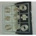 A GLASS CRYSTAL 10 PIECE TIC TAC TOE SET WITH A MIRRORED BOARD IN GOOD CONDITION SOLD AS IS