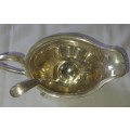 A VINTAGE SILVER PLATED SAUCE BOAT AND LADEL SOLD AS IS