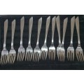 A VINTAGE SET OF FISH KNIVES AND FORKS MADE BY KRIIUS SOLINGEN SOLD AS IS