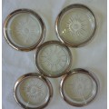 A VINTAGE SET OF FIVE GLASS COASTERS WITH SILVER PLATED BRIMMS SOOD AS IS