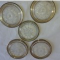 A VINTAGE SET OF FIVE GLASS COASTERS WITH SILVER PLATED BRIMMS SOOD AS IS