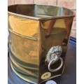 A BRASS VINTAGE PLANTER WITH LION HEAD HANDLES SOLD AS IS