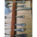 AN ANTIQUE DESERT CAKE SERVING SET IN ITS ORIGINAL BROWM CASE SOLD AS IS
