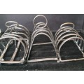 A COLLECTION OF 4 TOAST AND PLATE HOLDERS EPNS VINTAGE SOLD AS IS