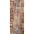 A CYLINDRICAL PERFPEX FLOWER VASE APPROXIMATELY 60CMS TALL SOLD AS IS