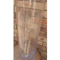 A CYLINDRICAL PERFPEX FLOWER VASE APPROXIMATELY 60CMS TALL SOLD AS IS