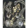 A VINTAGE JOBLOT SILVER TONE AND PLATED COSTUME NECKLACES SOLD AS IS