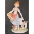 A FARM GIRL WITH HER DOG CARRYING FLOWER PORCELAIN FIGURINE SOLD AS IS