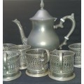 A VINTAGE TEA POT JUG ELECTRO PLATED SILVER AND SIX SILVER PLATED TEA GLASS HOLDERS