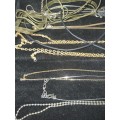 A COLLECTION OF VINTAGE GOLDPLATED AND SILVERPLATED NECKLACES AND PENDANTS