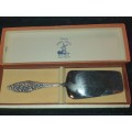 A RARE SILVER NICKLE PLATED CAKE CUTTER MADE IN HOLLAND SOLD AS IS
