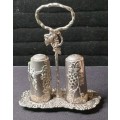 AN ORNATE SILVER PLATED SALT AND PEPPER STAND AND TWO SHAKERS SOLD AS IS
