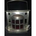 AN ANTIQUE  STAINLESS STEEL LANTETRN WITH A RED GLASS INSERT SOLD AS IS