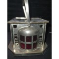 AN ANTIQUE  STAINLESS STEEL LANTETRN WITH A RED GLASS INSERT SOLD AS IS