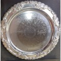 A ROUND STAINLESS STEEL MADE IN HONG KONG SERVING TRAY SOLD AS IS