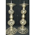 A PAIR OF BRONZE CANDLE STANDS ORNATELY DESIGNED SOLD AS IS