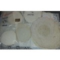 A vintage job lot cotton and Poly plastic doilies and coasters sold as is