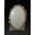 An ornate pewtal alloy oval picture frame in good condition sold as is