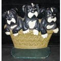 A heavy cast iron metal three puppies in a basket door stopper made in China sold as is