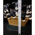 A heavy cast iron metal three puppies in a basket door stopper made in China sold as is