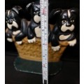 A heavy cast iron metal three puppies in a basket door stopper made in China sold as is