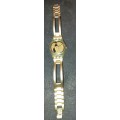 A VINTAGE WOMANS GOLD TONE SWATCH WATCH WORKING NOT TESTED SOLD AS IS