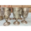 A VINTAGE COLLECTION OF SILVER PLATED TOT AND SHERRY CUPS WITH AN INTRICATE GRAPE VINE DESIGN
