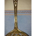 A SET OF ORNAMENTAL BRASS LADEL AND FORK MADE IN ISREAL LENGTH 35 TO 40 CENTIMETERS SOLD AS IS