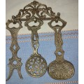 A SET OF 4 BRASS KITCHEN ORNAMENTAL CUTLERY MADE IN ISREAL SOLD AS IS