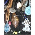 A BULK COLLECTION OF LEATHER ROPE COSTUME NECKLACES SOLD AS IS