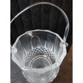 A FANCY CRYSTAL GLASS TYPE ICE BUCKET AND TONGS SOLD AS IS