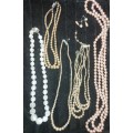 A VINTAGE COLLECTION OF SIMULATED PEARL NECKLACES AND A PAIR OF EARRINGS SOLD AS IS