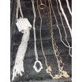 A COLLECTION OF SILVER PLATED AND STAINLESS STEEL NECKLACES WITH PENDANTS SOLD AS IS
