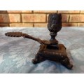 AN ANTIQUE CAST ALLOY CANDLE HOLDER