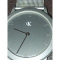 TWO CK SILVER PLATED WRIST WATCHES SOLD AS IS NOT TESTED