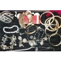 A COLLECTION OF VINTAGE COSTUME BRACELETS AND BANGLES SOLD AS IS