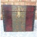 AN ANTIQUE WOODEN CHEST WITH INTRICATE BRONZE WORK