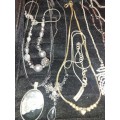 A VINTAGE JOB LOT SILVER PLATED AND STAINLESS STEEL COSTUME NECKLACES SOLD AS IS