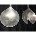 A  pair of stainless steel salad ladles sold as is